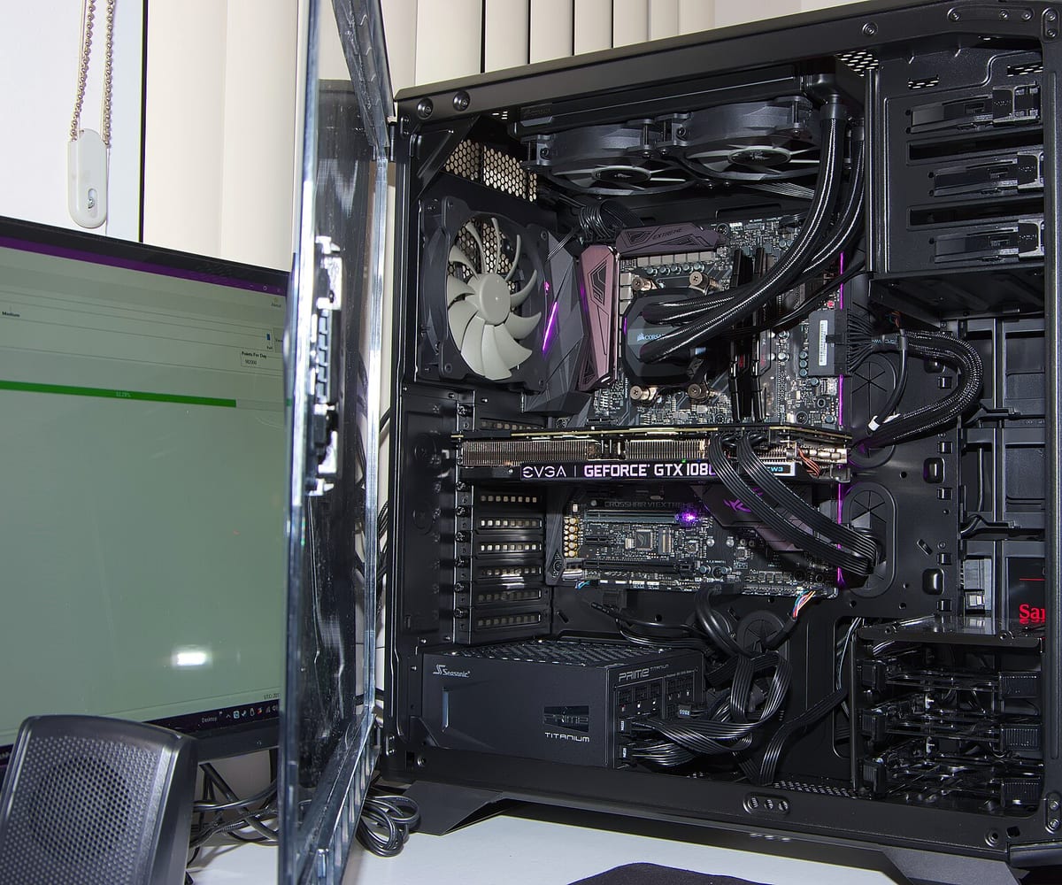 The inside of a finished desktop computer build, showing the graphics card, cooler and tidied cabling.